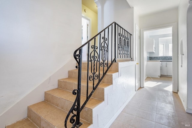 staircase featuring tile patterned floors