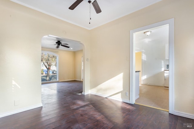 empty room with ceiling fan and dark hardwood / wood-style floors