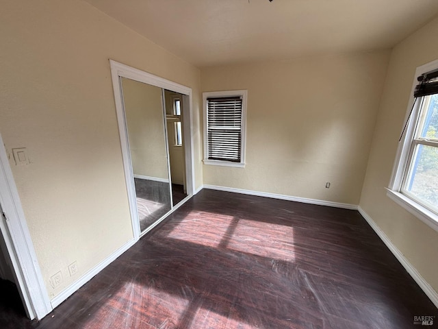 unfurnished room featuring dark wood-type flooring