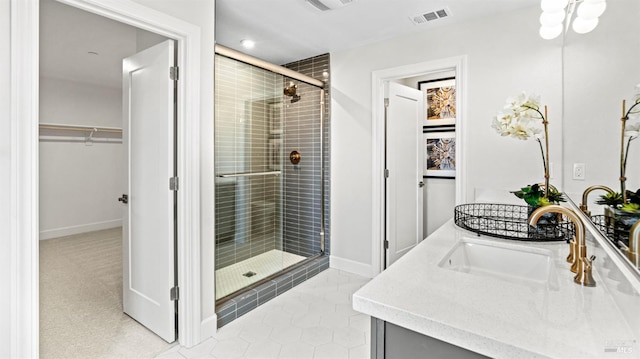 bathroom with vanity, tile patterned floors, and a shower with door