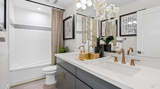 full bathroom with vanity, toilet, wood-type flooring, and shower / tub combo with curtain