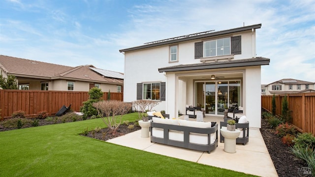 back of house featuring a yard and an outdoor living space