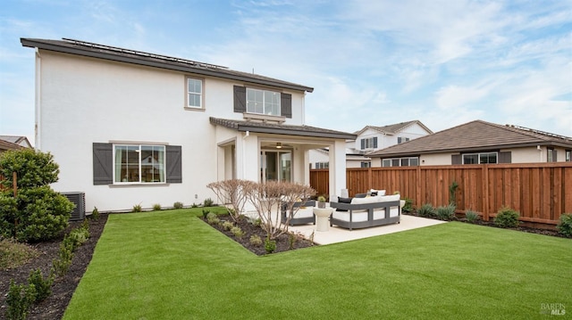 rear view of house with an outdoor hangout area, central AC unit, a patio area, and a lawn