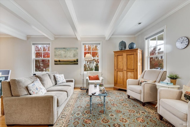 living room with crown molding, beamed ceiling, and light wood-type flooring