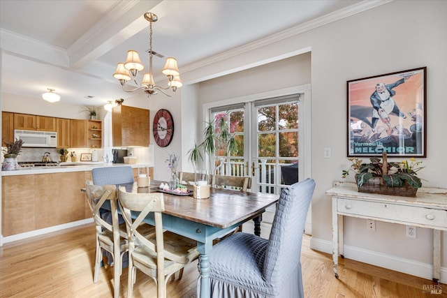 dining area with ornamental molding, beamed ceiling, a chandelier, and light hardwood / wood-style floors