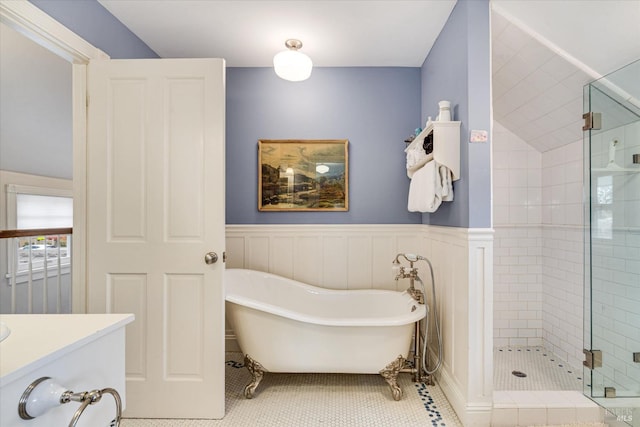 bathroom with tile patterned floors, vanity, and shower with separate bathtub