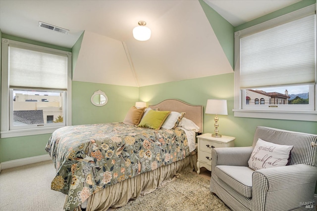 carpeted bedroom with lofted ceiling