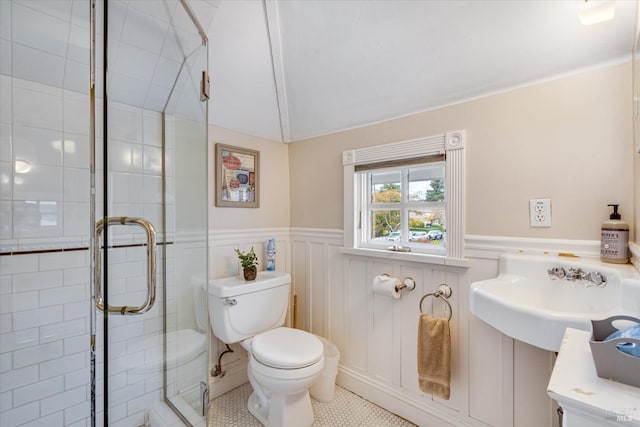 bathroom featuring tile patterned floors, sink, a shower with door, and toilet