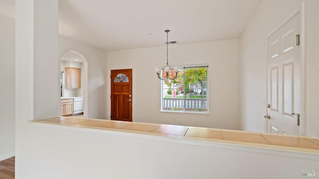 interior space with visible vents, a chandelier, and wood finished floors