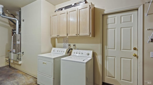 clothes washing area featuring cabinets and washing machine and clothes dryer