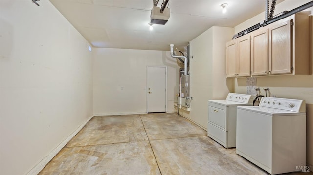 laundry area with a garage, washing machine and clothes dryer, cabinet space, and baseboards