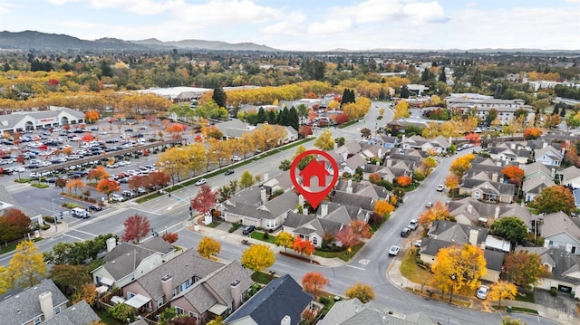 drone / aerial view featuring a residential view and a mountain view