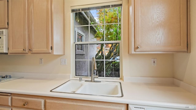 kitchen featuring light brown cabinetry and sink