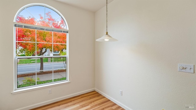 unfurnished room with hardwood / wood-style flooring