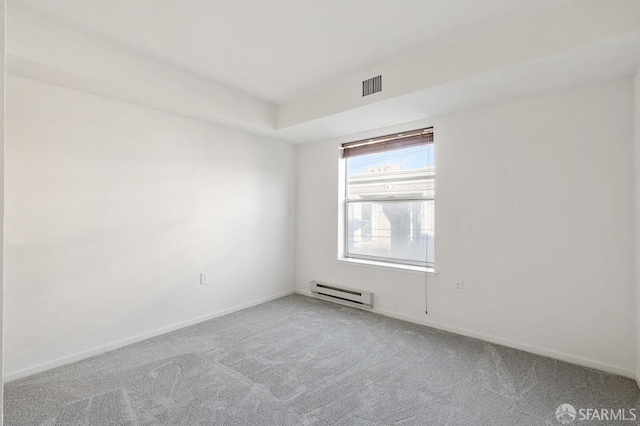 empty room featuring carpet flooring and a baseboard radiator