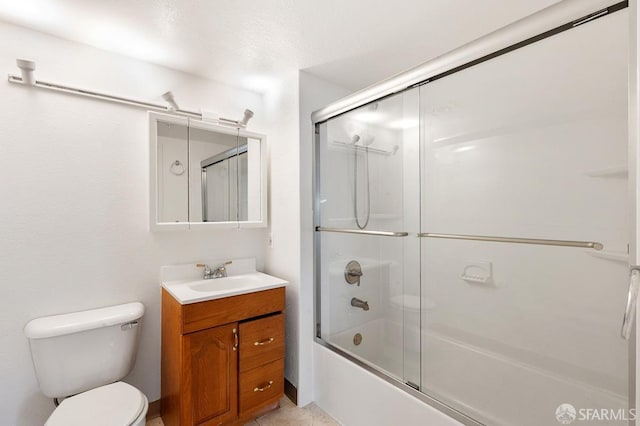 full bathroom with shower / bath combination with glass door, vanity, and toilet