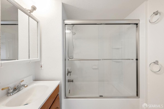 bathroom with vanity and enclosed tub / shower combo