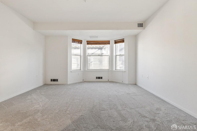 unfurnished room featuring light colored carpet