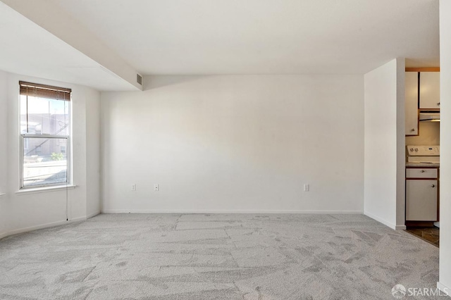 unfurnished room featuring light colored carpet