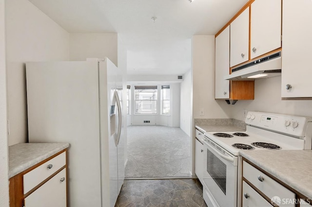 kitchen featuring white cabinets, dark carpet, and white appliances