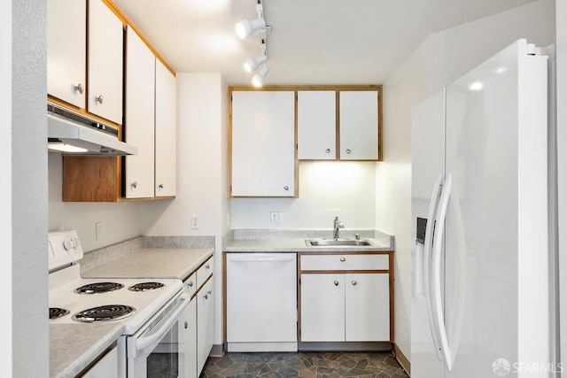 kitchen with white cabinetry, sink, track lighting, and white appliances