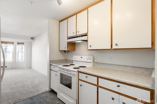 kitchen featuring electric stove, white cabinets, and dark carpet