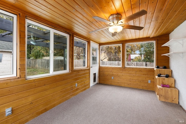 sunroom featuring a wealth of natural light, wooden ceiling, and ceiling fan