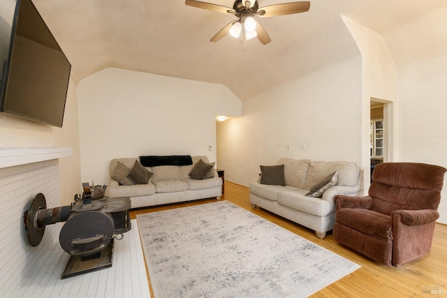 living room with light hardwood / wood-style flooring, ceiling fan, and lofted ceiling