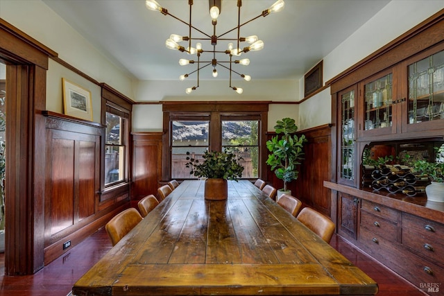 dining room featuring a notable chandelier and dark hardwood / wood-style flooring