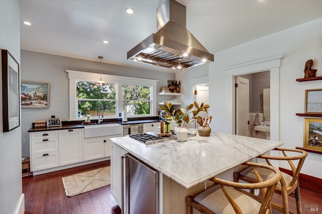 kitchen featuring pendant lighting, wine cooler, dark stone counters, a kitchen island, and island range hood