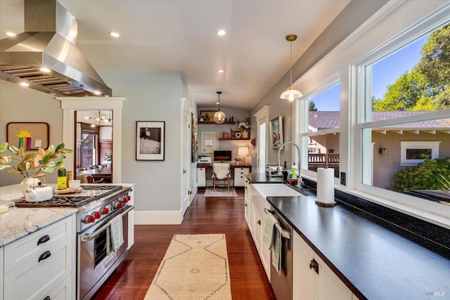 kitchen with white cabinets, appliances with stainless steel finishes, island exhaust hood, hanging light fixtures, and vaulted ceiling