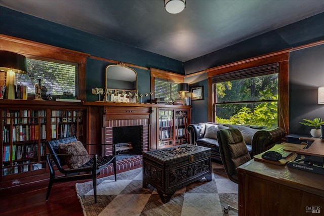 office area featuring a fireplace and wood-type flooring