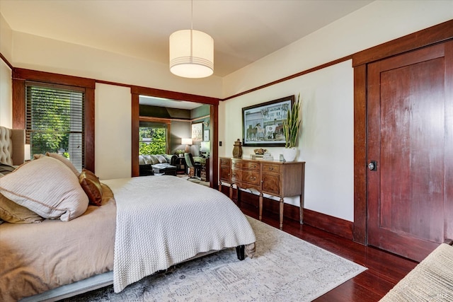 bedroom with dark wood-type flooring