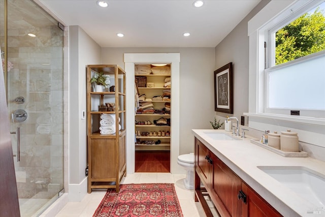 bathroom featuring vanity, toilet, tile patterned floors, and an enclosed shower