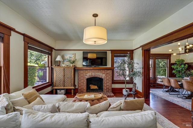 living room with dark hardwood / wood-style floors and a fireplace