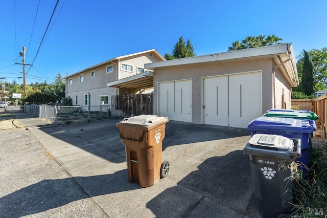 view of front facade featuring a garage and an outdoor structure