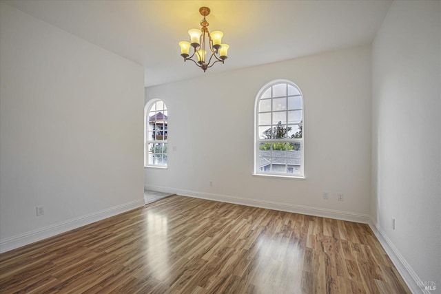 dining area featuring light wood-type flooring and a notable chandelier