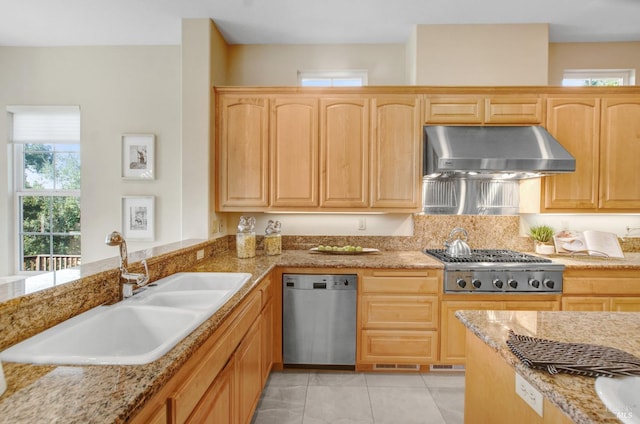 kitchen with under cabinet range hood, light brown cabinets, appliances with stainless steel finishes, and a sink