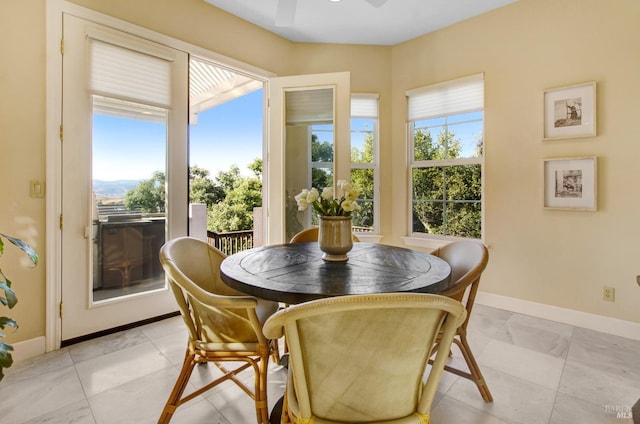 dining room featuring baseboards and ceiling fan