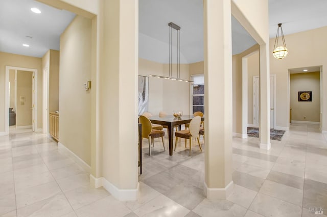 hallway featuring light tile patterned floors, recessed lighting, and baseboards