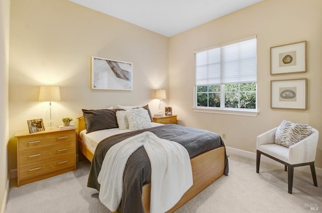 bedroom featuring light carpet and baseboards