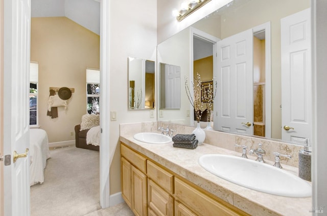 full bathroom featuring ensuite bath, double vanity, lofted ceiling, and a sink