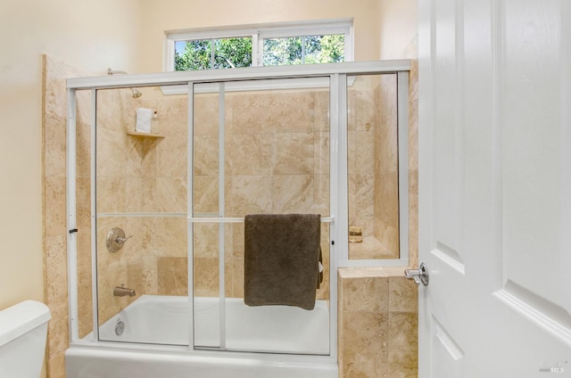 full bath with a wealth of natural light, enclosed tub / shower combo, and toilet