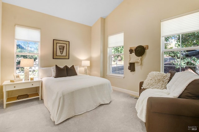 carpeted bedroom with visible vents, baseboards, and vaulted ceiling