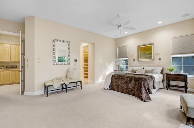 bedroom with light carpet, recessed lighting, baseboards, and ceiling fan