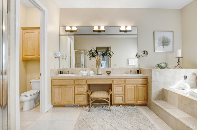 bathroom with a sink, double vanity, a stall shower, and tile patterned floors