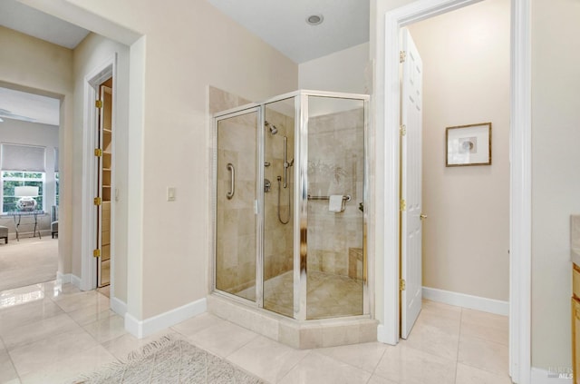 bathroom with baseboards, a stall shower, and tile patterned flooring