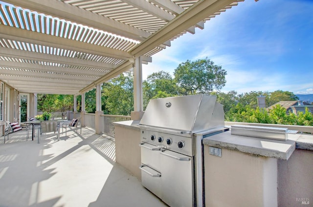 view of patio / terrace featuring area for grilling, a grill, and a pergola