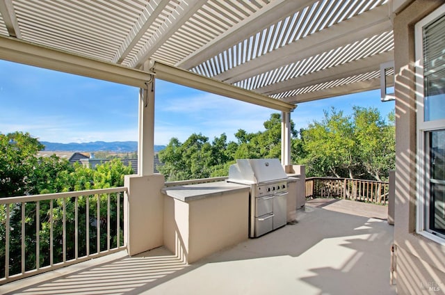 view of patio / terrace featuring area for grilling, a mountain view, and a pergola