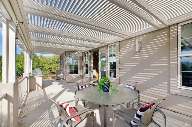 view of patio / terrace with a pergola and outdoor dining area